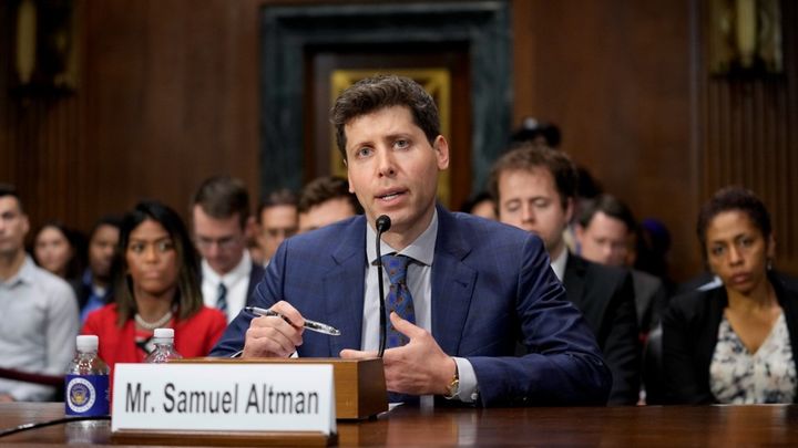 Photo of a man speaking before US Congress with a name tag “Mr. Samuel Altman”.